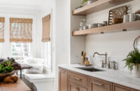 A pretty light oak stain color on a row of base cabinets and a set of floating shelves.