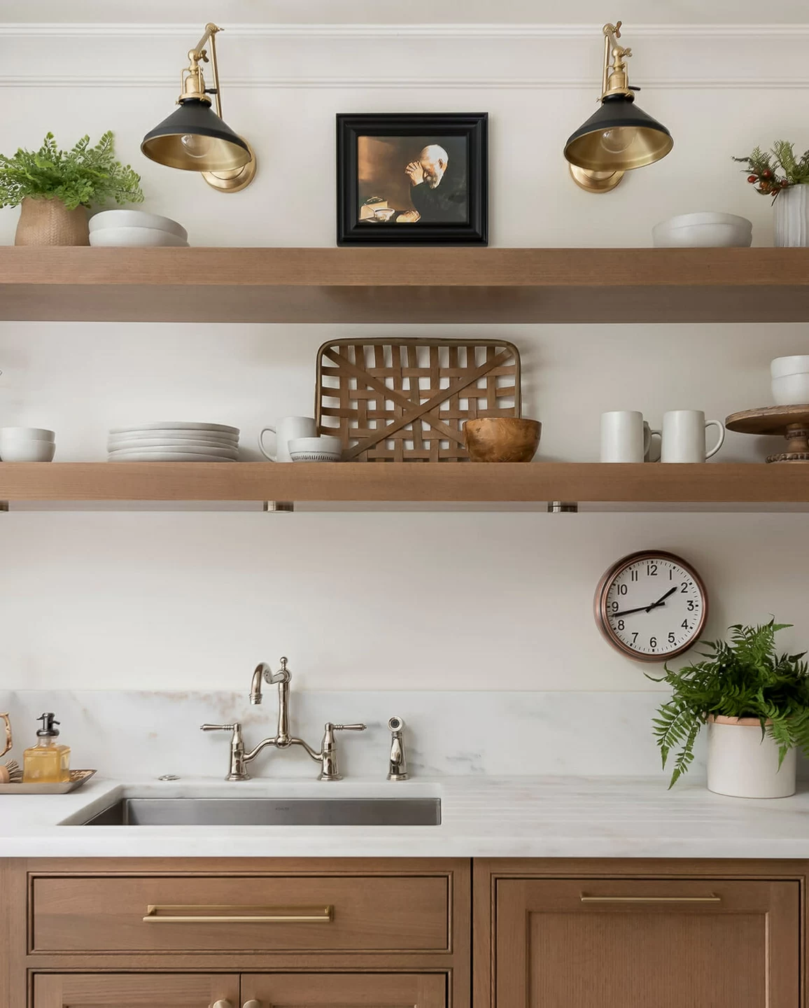 A wall with light oak base cabinets and sleek, simple floating shelves instead of wall cabinets.