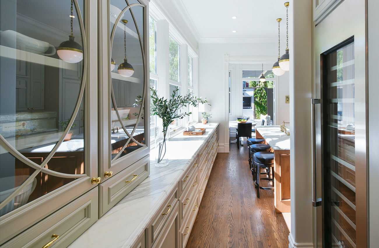 A classy all gray kitchen design with a traditional interior design style. A beautiful mullion cabinet door with plain glass has a curved design pattern that is delicate and elegant. Start looking at other kitchens to spark your own creativity. Our Design + Style Gallery and Inspiration Gallery both provide a vast array of concepts sure to please.