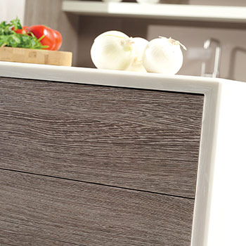 A close up of a textured wood shiplap panels on the back of a kitchen island with american made cabinets from Dura Supreme Cabinetry.