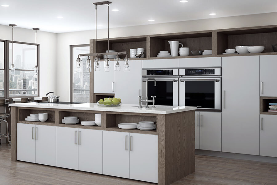 An urban loft kitchen designed for modern city living. This two-tone kitchen combines an off-white light gray painted cabinet doo with a slab style accented with a gray stained weathered wood for the open cabinets, shelves, and kitchen island end cap with a J-panel. Contemporary kitchen design style is modern and cutting-edge. Learn more about interior design styles and how to incorporate a style into cabinetry.