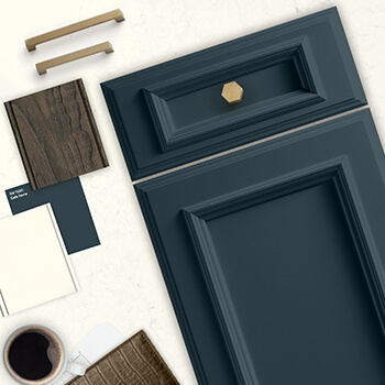 An on-trend kitchen design idea with a dark blue painted cabinet door, white painted cabinet sample, weathered wood, and brushed brass hardware. Discover your interior design style before remodeling your kitchen to have a look that you are sure to love for many years.