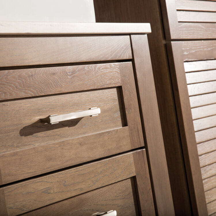 A close up of the beautiful factory finish on a stained wood vanity cabinet by Dura Supreme Cabinetry