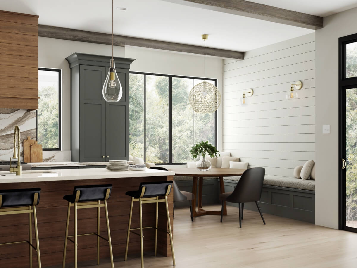 A kitchen breakfast nook with a large beautiful pendant light over the kitchen table with banquette seating with cabinetry boot bench seats.