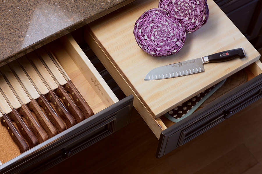 The kitchen Prep Zone is the dedicated work center where meals are prepped and combined prior to being cooked. This prep workspace has lots of storage below the countertop for preparing food including a drawer cutting board and a drawer knife block for cutlery.