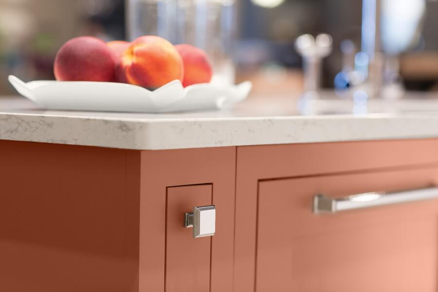 A peachy, coral, cavern clay custom painted kitchen island cabinet created with Dura Supreme's simplified and affordable Personal Paint Match program.
