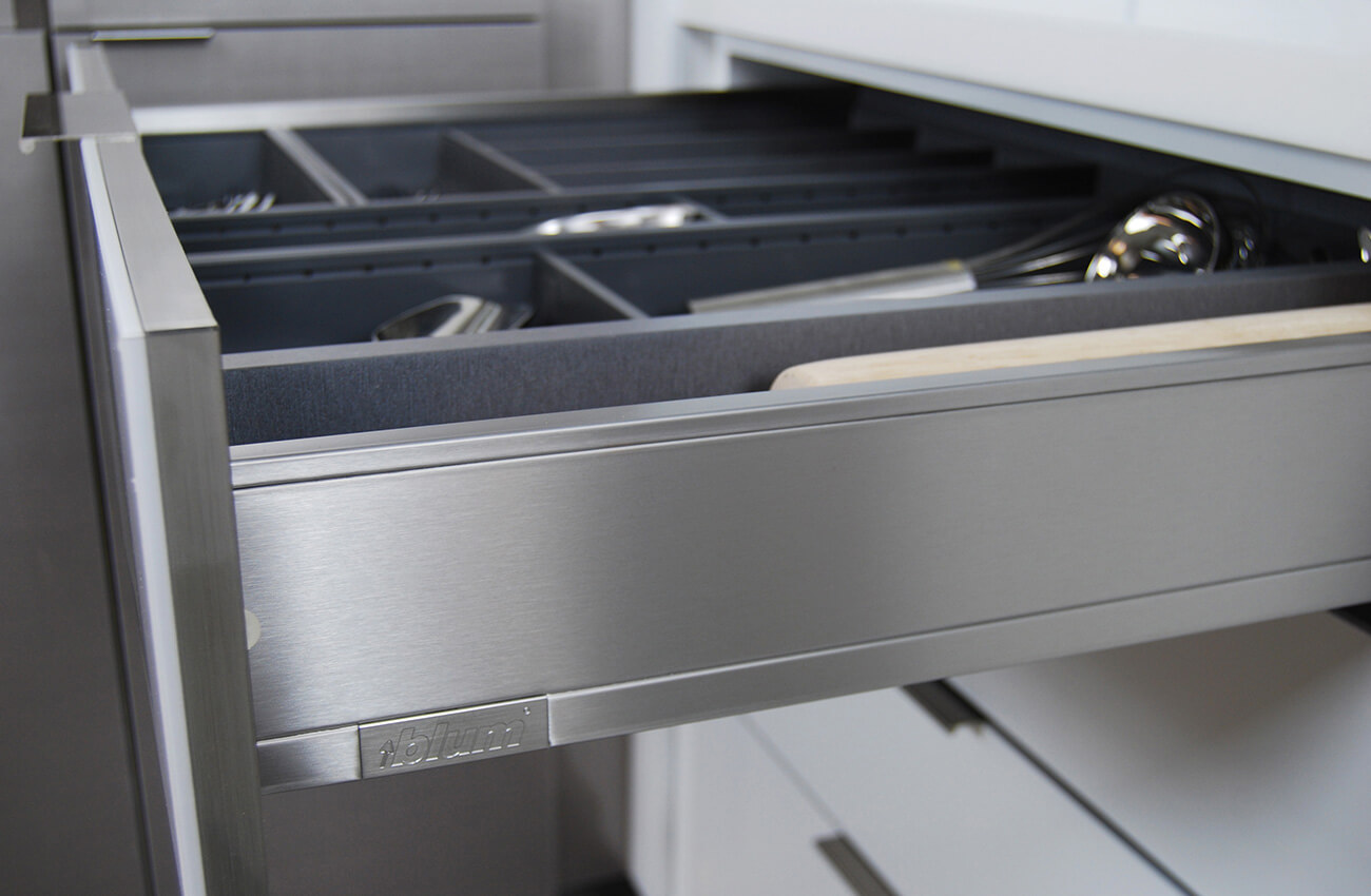 Contemporary cabinetry storage with modern stainless steel drawer boxes. Dura Supreme's frameless and full-access kitchen cabinets.