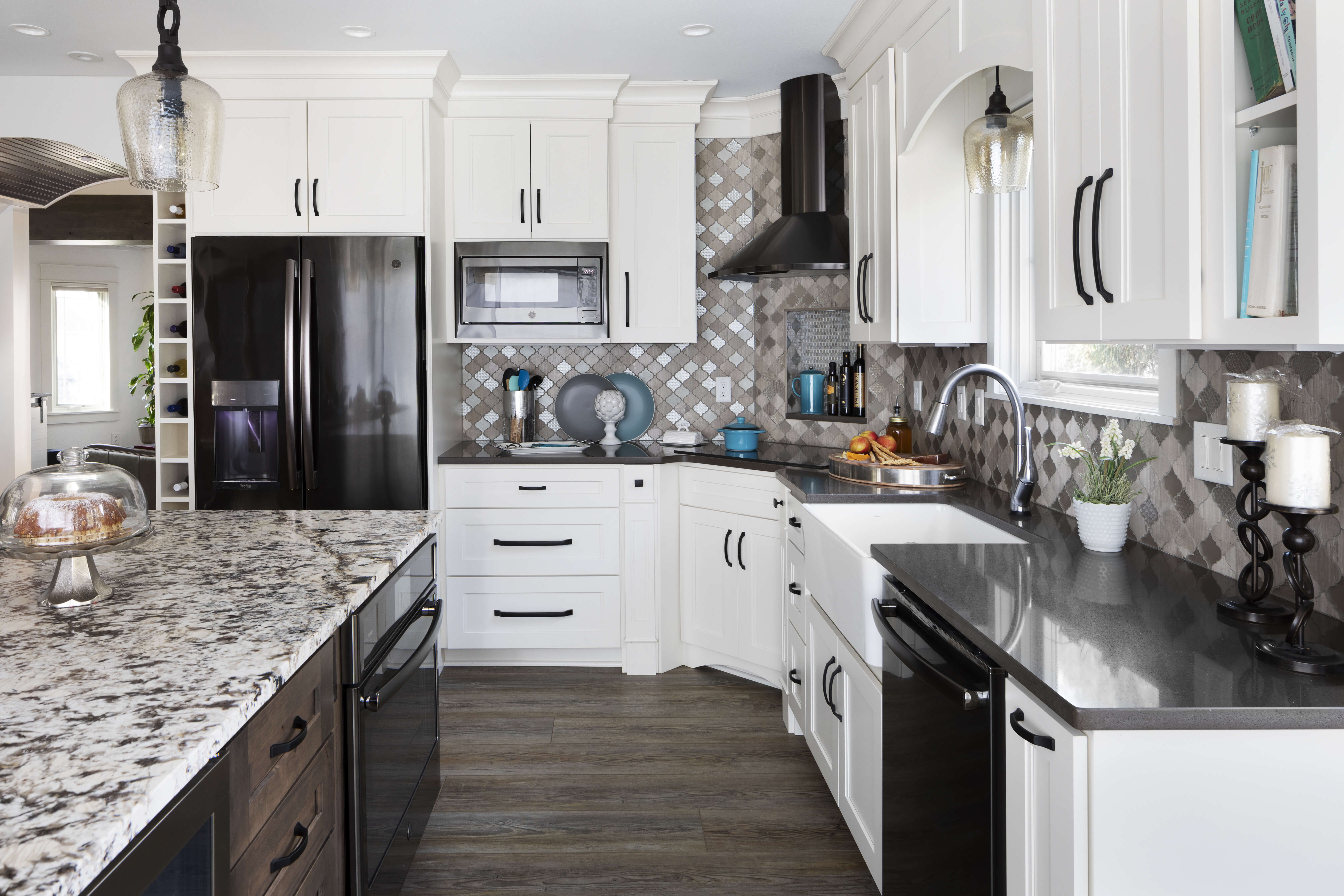 light brown kitchen cabinet with black appliances