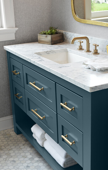 A custom painted furniture style bathroom vanity with inset cabinets using Crestwood Cabinetry from Dura Supreme.