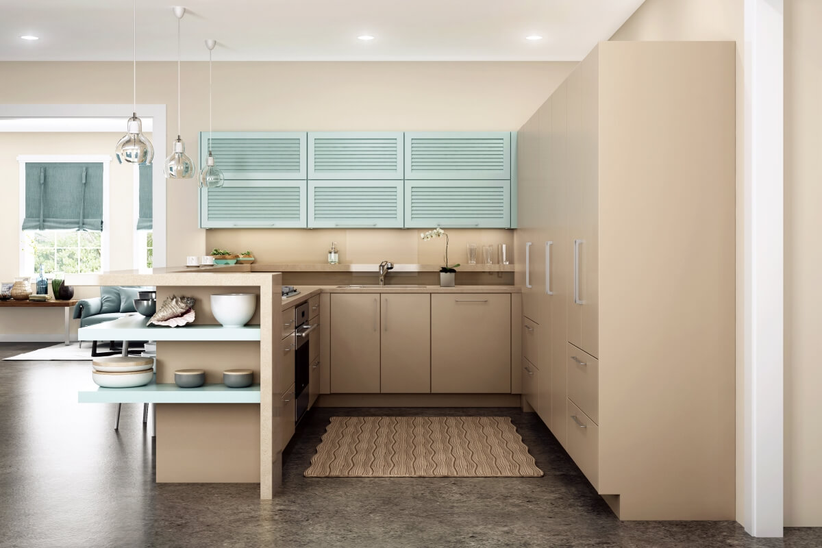 This modern kitchen reno uses a beach-inspired color palette with warm sandy tan paints, beige colors, and sea green painted accent cabinets. Cabinetry by Dura Supreme Cabinetry.