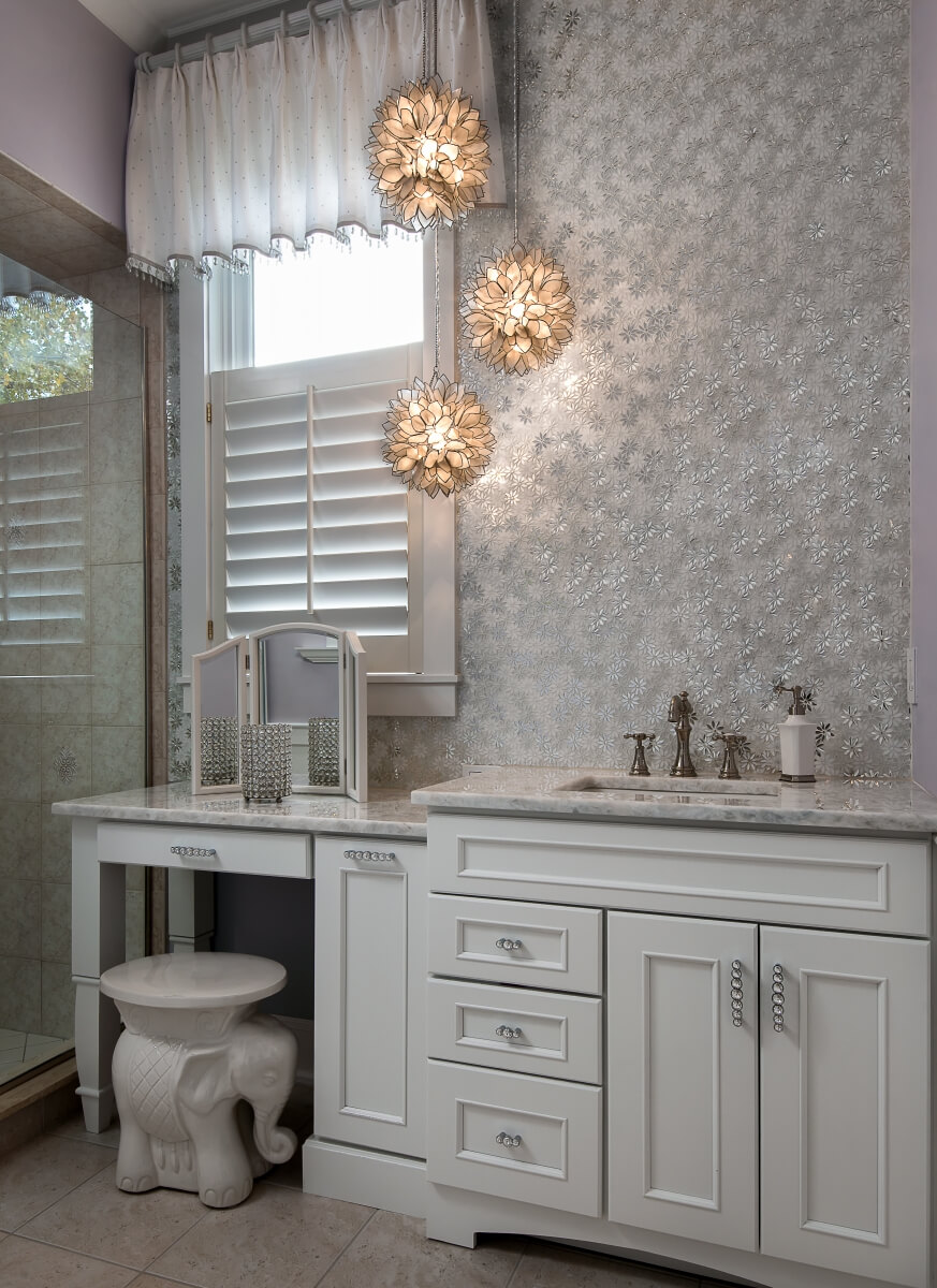 Pale gray painted bathroom vanity cabinets look like a classic off-white color in a kitchen or a bathroom design.