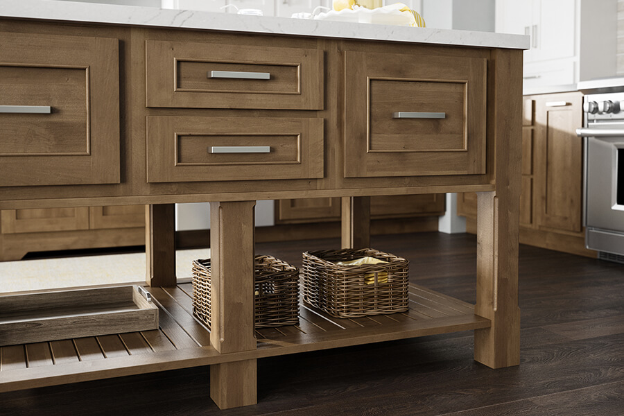 A kitchen island with standard overlay cabinet door construction on stained wood cabinets by Dura Supreme Cabinetry.