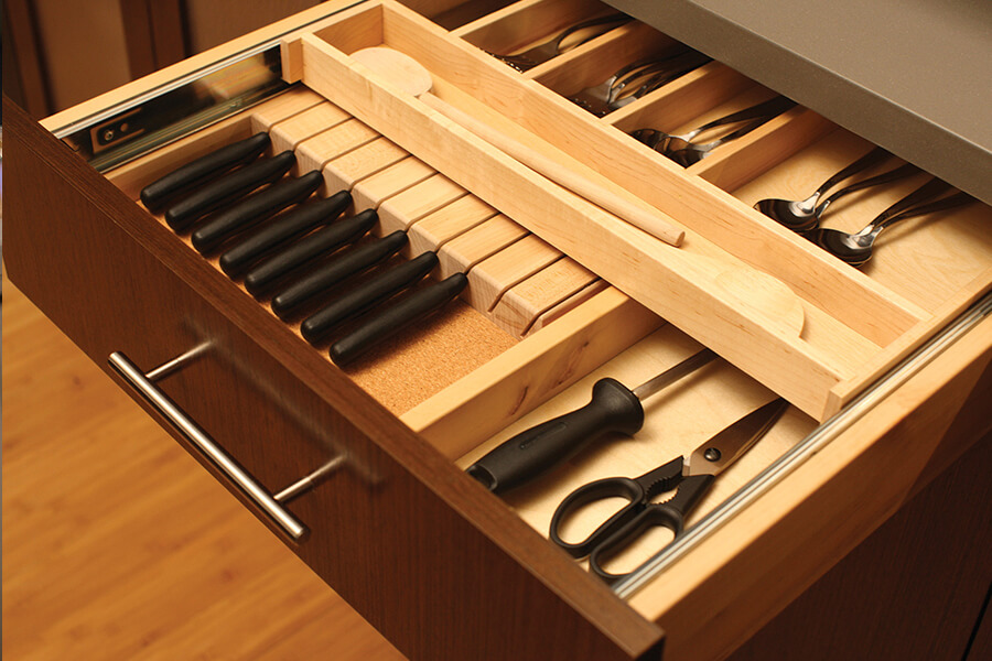 Frameless kitchen cabinet drawers with organized storage also have more accessible storage due to the cabinet box construction method. Frameless cabinets offer more accessibility verses framed cabinets. This is due to the fact that there is not an inside edge of a frame projecting into the cabinet opening. This allows an easier access to the cabinet interior as well as a larger opening to store plates, platters and cookware. The larger opening also allows for a wider drawer box in the frameless cabinetry compared to the framed cabinets of the exact same width.