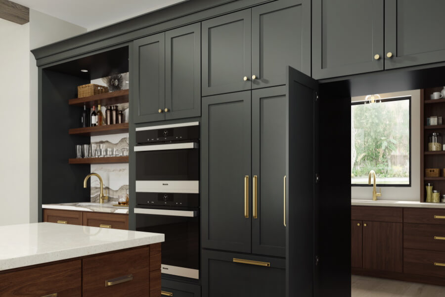 A walk thru pantry cabinet door hides a full butler's pantry in a modern farmhouse style kitchen with green cabinets.