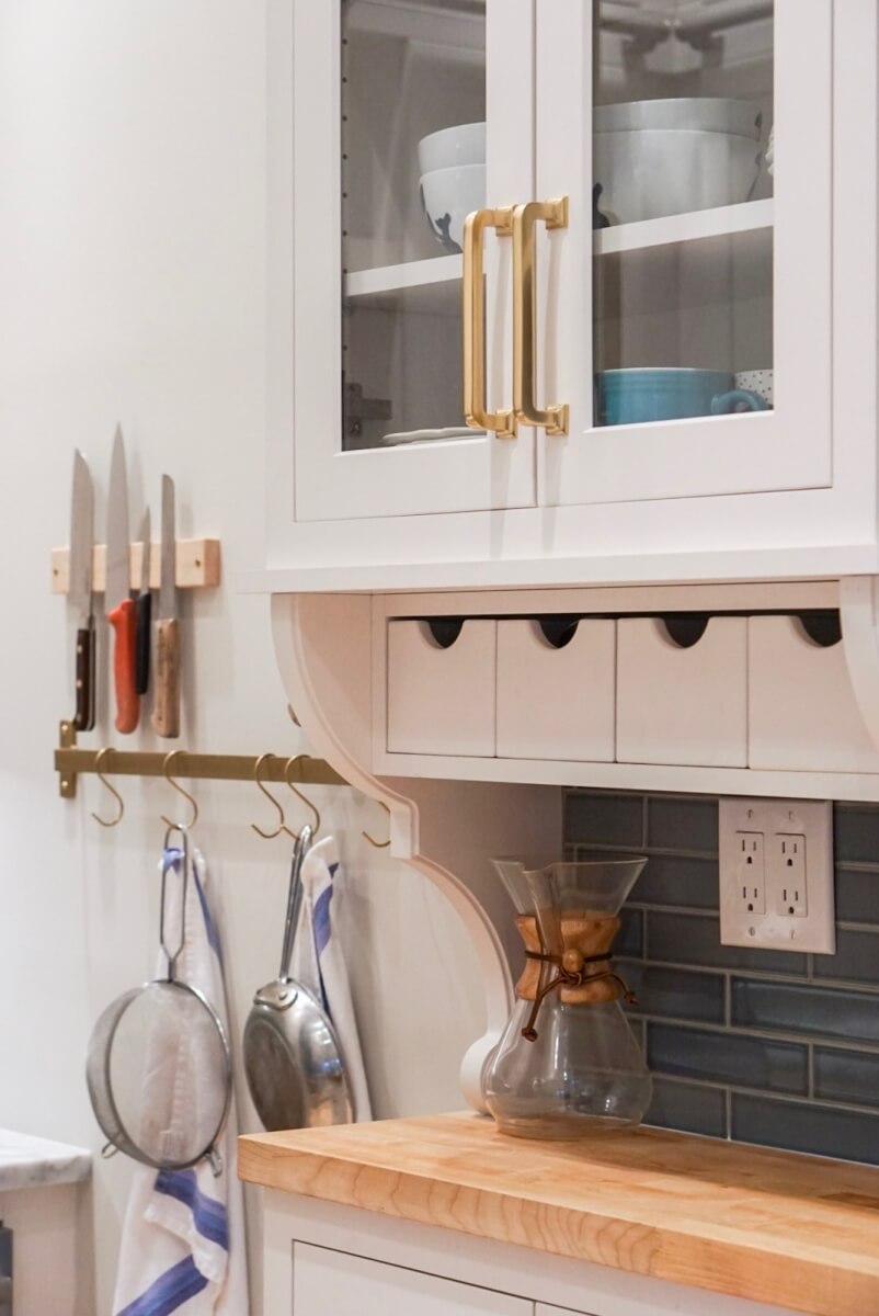 A shallow, hutch-like space catches your eye as you step into this kitchen. 