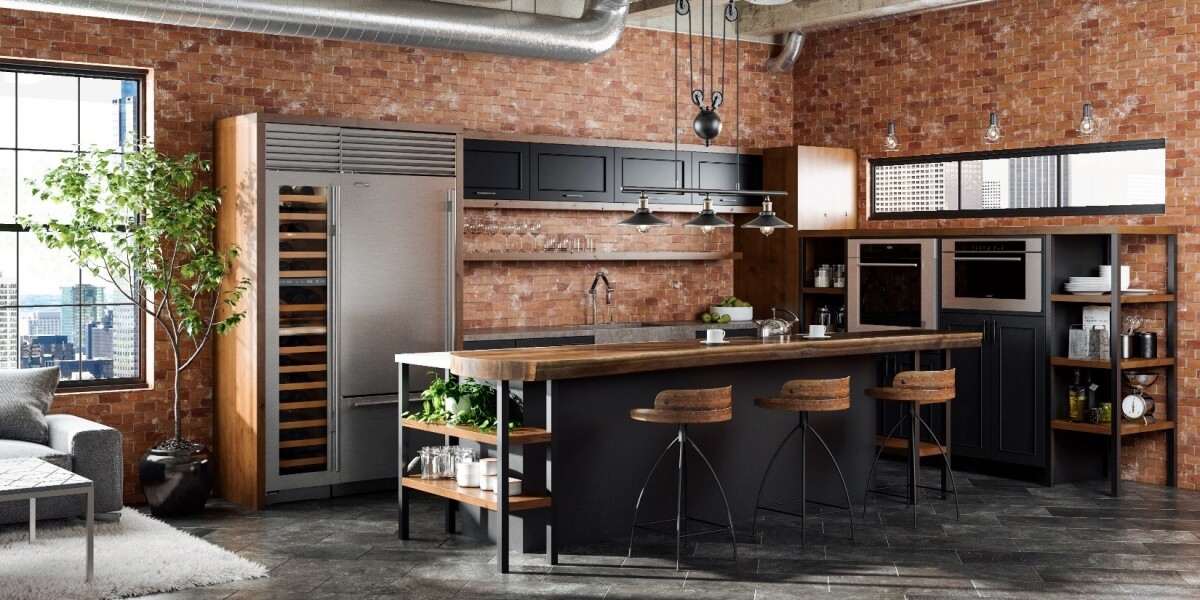 Industrial style urban loft ktichen design with black painted cabinets with warm rich wood finishes and red brick walls. This kitchen remodel features a stunning kitchen island with a wood countertop and lots of industrial features.