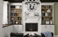 Dark wood ceiling beams around the perimeter of this hearth room define the space, all Dura Supreme Cabinetry