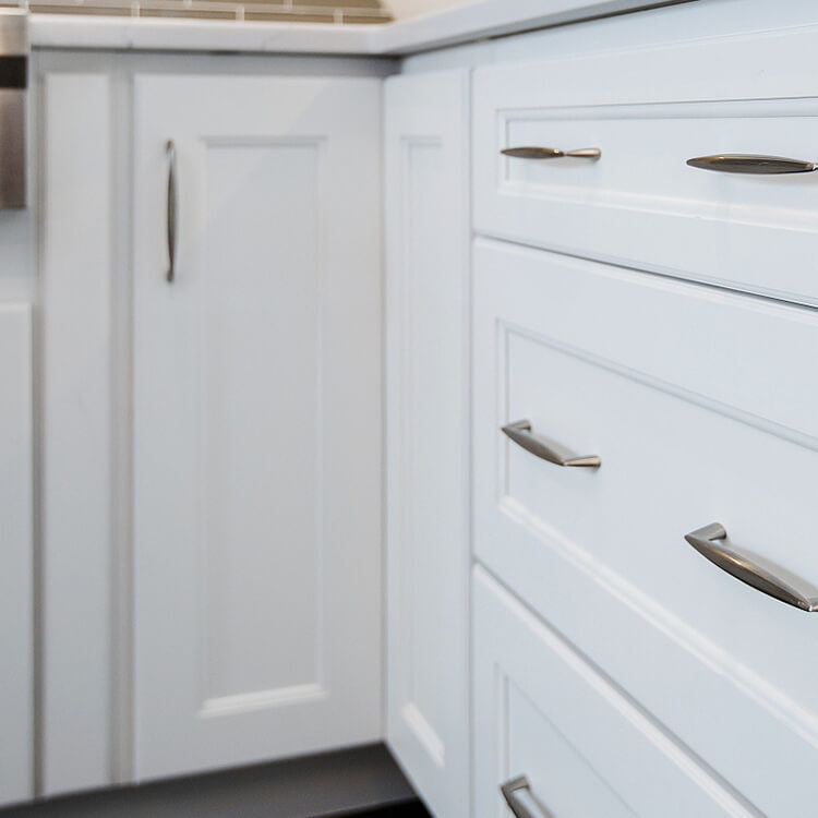 Corner Base Cabinets That Maximize Your Kitchen Storage Space. White cabinets showing a close up of a corner cabinet.