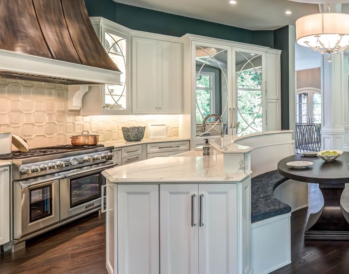 A grand kitchen design with mullion cabinet doors and a refrigerator with mirrored mullion doors to match the decorative cabinet doors. Dura Supreme kitchen design by Aaron Mauk of Mauk Cabinets by Design, Ohio.