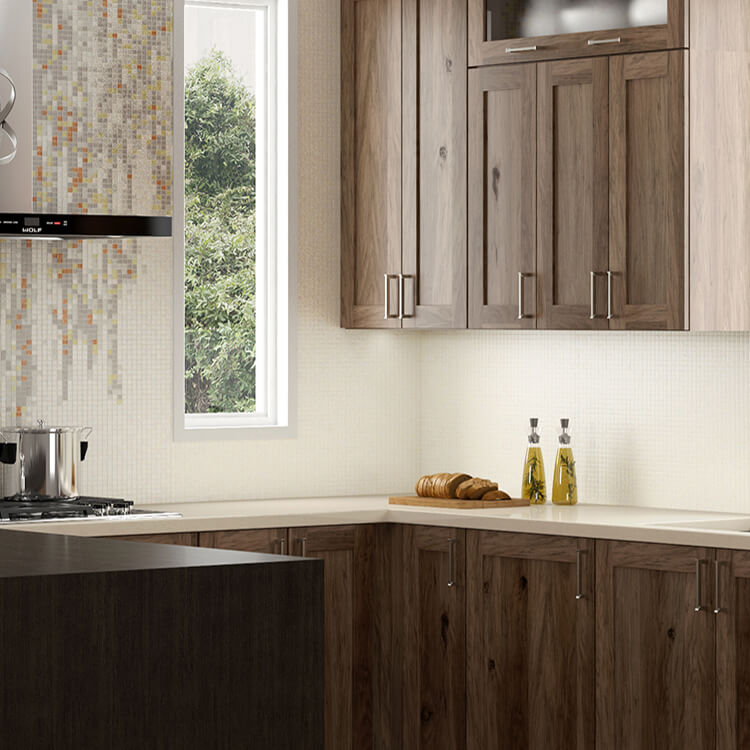 A close up of gray stained hickory cabinets in a transitional styled kitchen design.