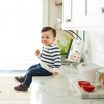 Learn how to remodel a kitchen smoothly. This little toddler boy is happy about his new kitchen from Dura Supreme Cabinetry. You’re going to be without your kitchen or bathroom for a while — rooms you and your family use and rely on multiple times each day — and getting by without those spaces can be a trying experience unless you’re prepared.