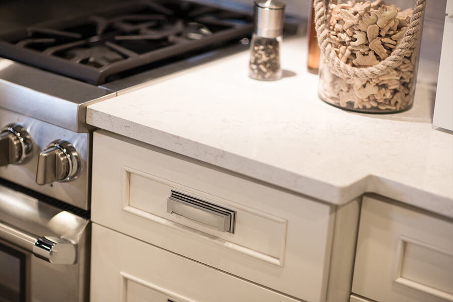 White on White is a mainstream color trend for kitchen designs all across the USA. The beautifully paired White cabinetry with White quartz countertops in this kitchen are a popular choice now and sure to be a long-time classic look for years to come.