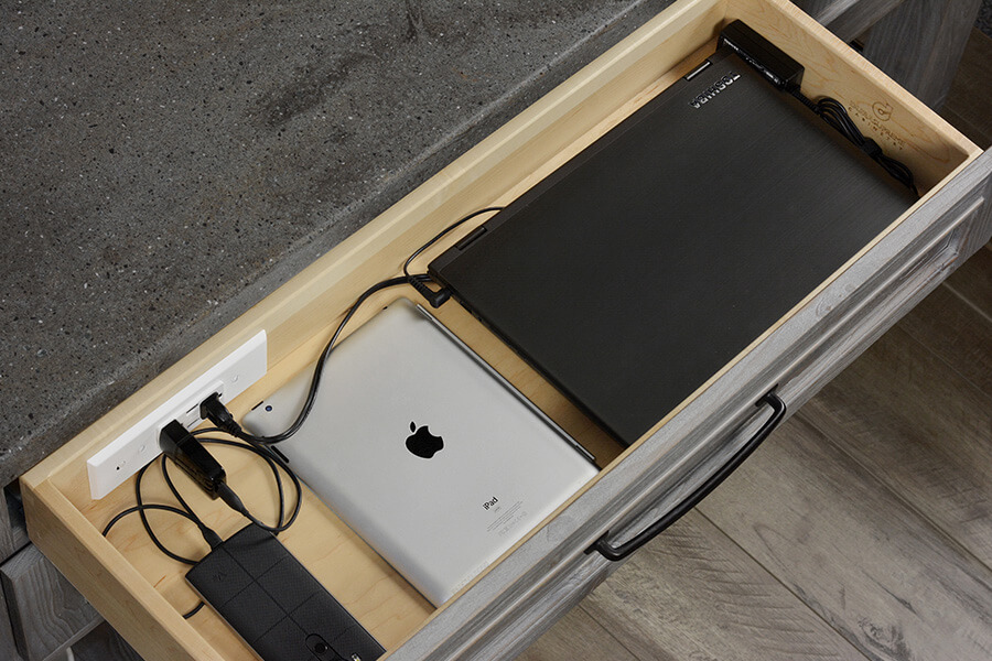 Kitchen design trends are using more integrated technology like this charging drawer for charging and powering electronic devices like mobile phones, tablets, and laptops. Learn about kitchen design trends from the expert trend forecasters at Dura Supreme Cabinetry.