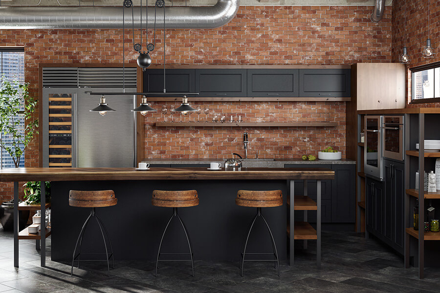 This industrial kitchen remodel in an urban loft embraces a black color palette with warm wood tones and brick textures. Black is a color trend that is forecasted to become a mainstream kitchen trend in a few years.