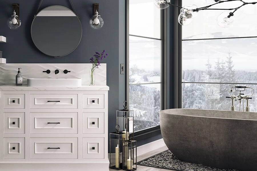 White painted oak vanity cabinets in a navy blue painted master bathroom. The painted oak finish as a beautiful texture and adds interest to the design.