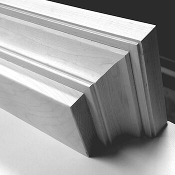 Shown in black and white, this close up of mantel shelf shows the quality craftmanship of the cabinet makers at Dura Supreme Cabinetry.