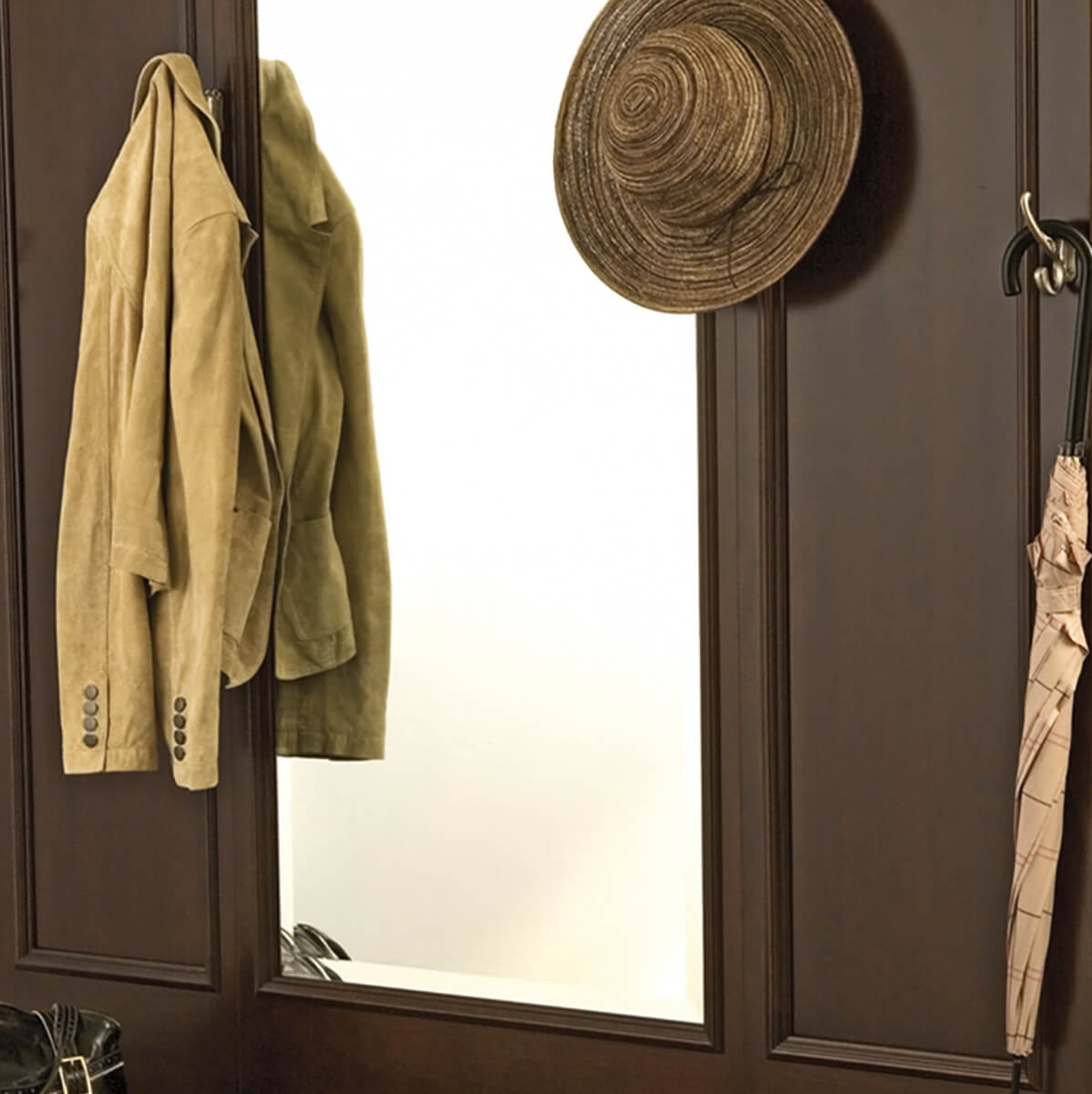 An entryway hall tree with a a large mirror to make the space feel larger and provide a space to double check your appearance before you leave the house.