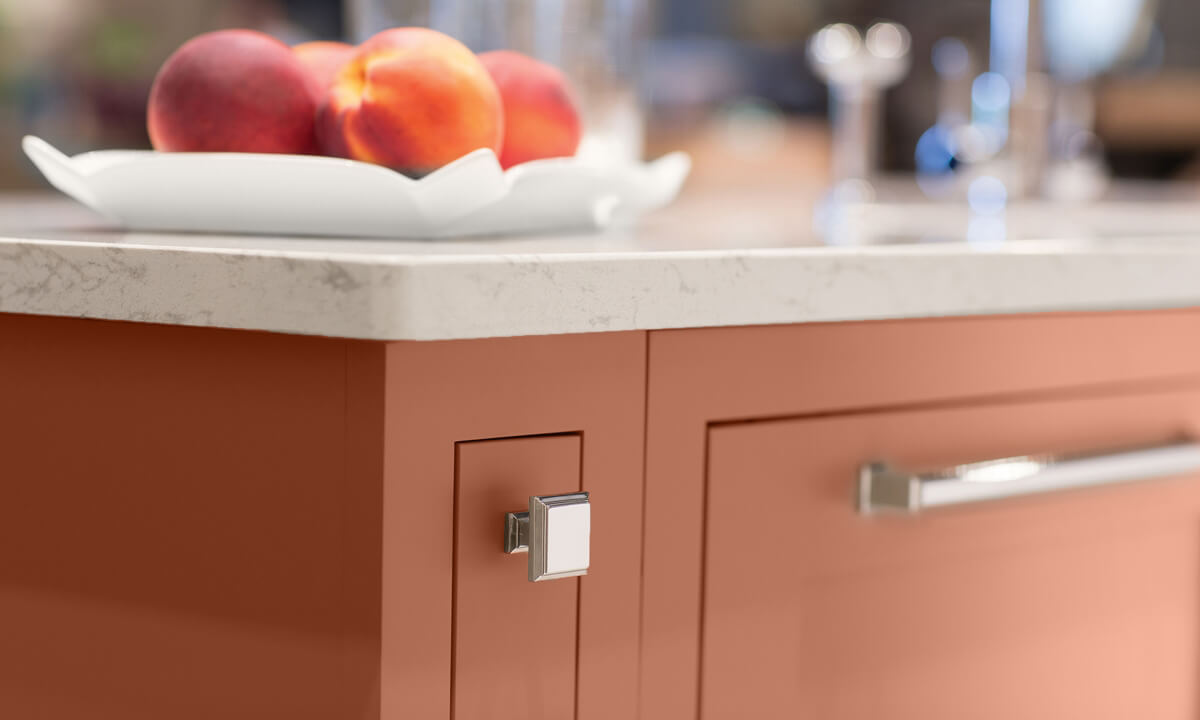 A peachy, coral, cavern clay custom painted kitchen island cabinet created with Dura Supreme's simplified and affordable Personal Paint Match program.