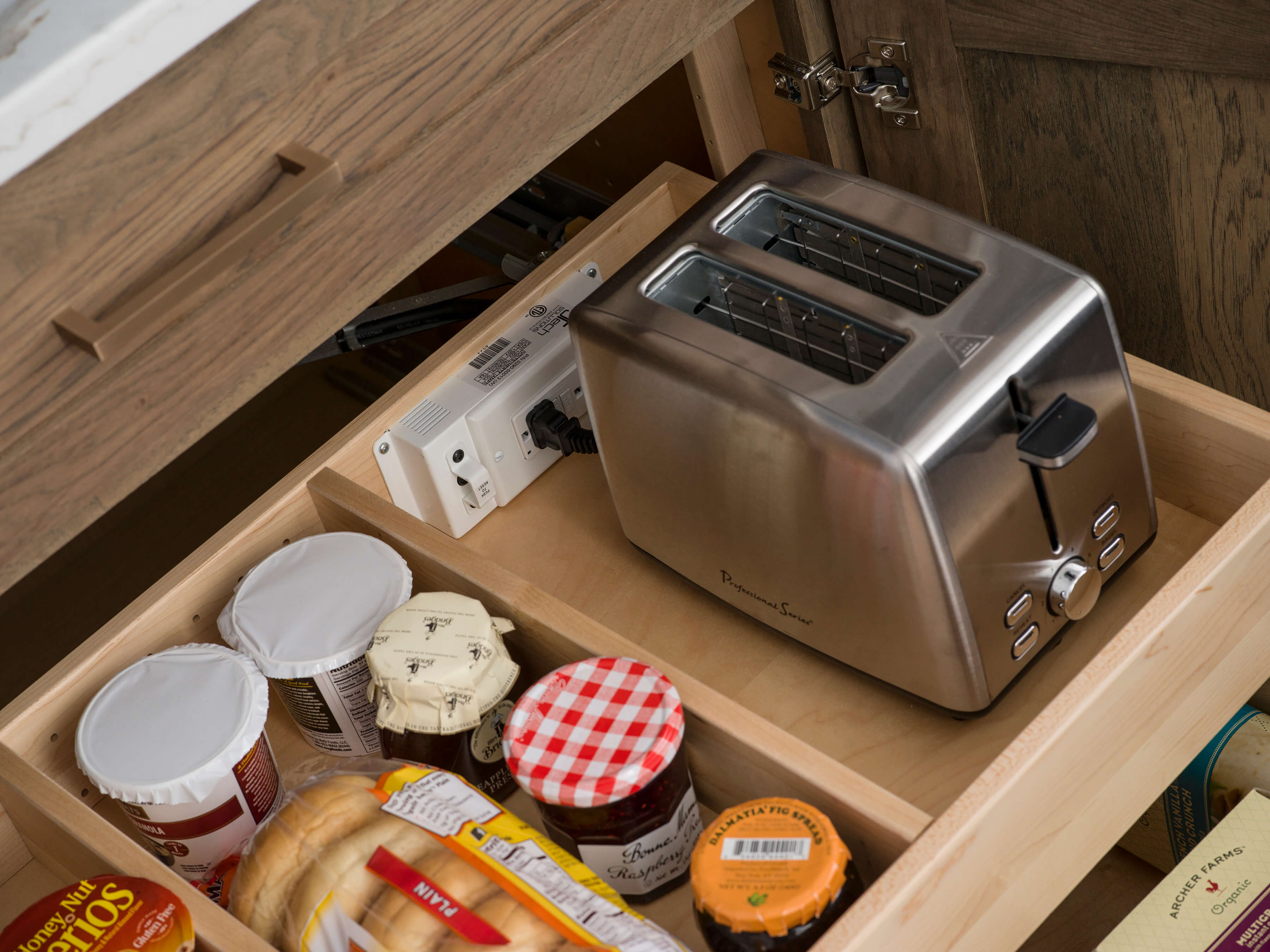 Roll-out shelves within a cabinet can be outfitted with a Dura Supreme power station or charging station for a variety of uses.