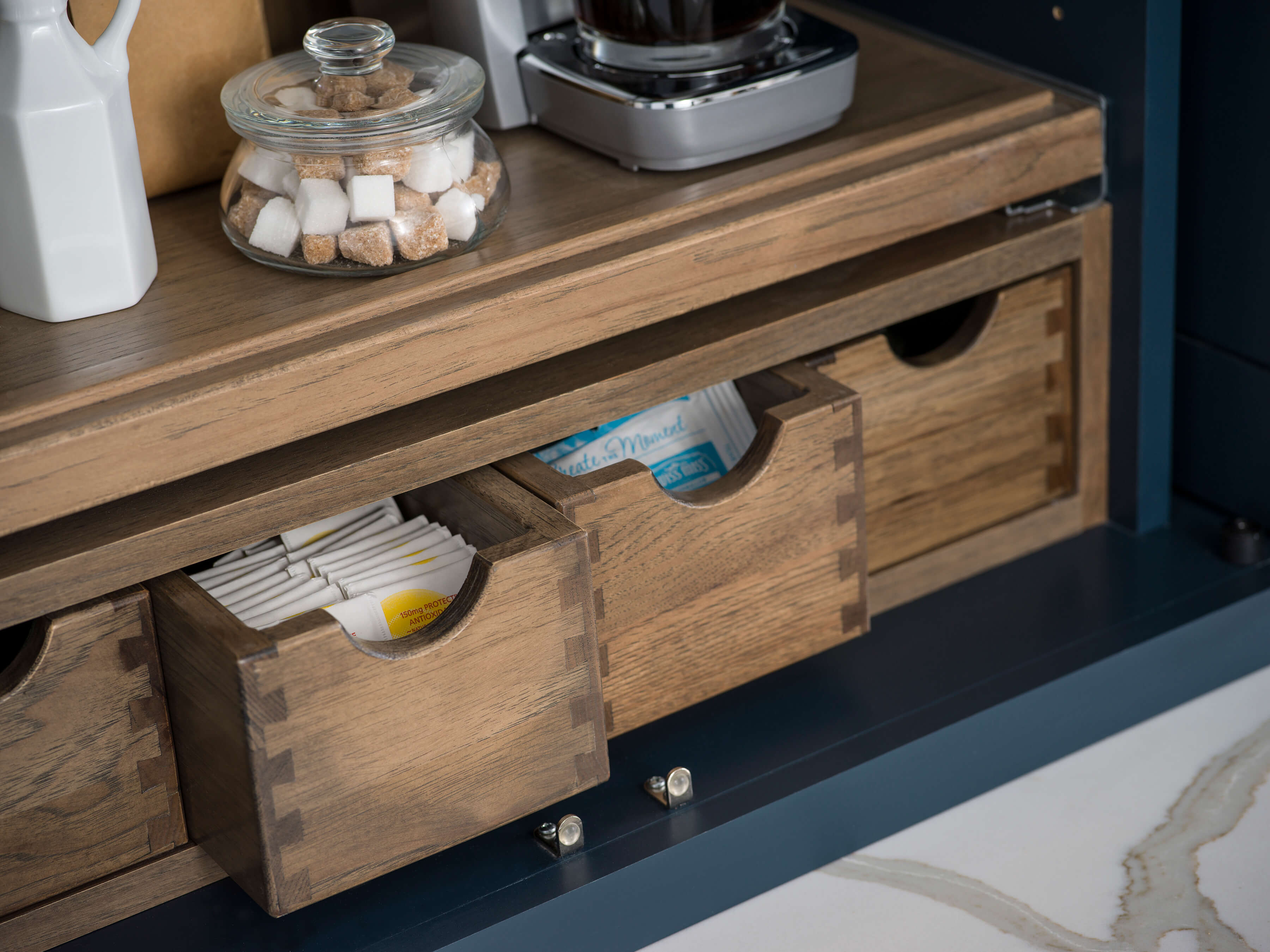 A close up of Apothecary Drawers inside a Beverage Center Larder from Dura Supreme Cabinetry