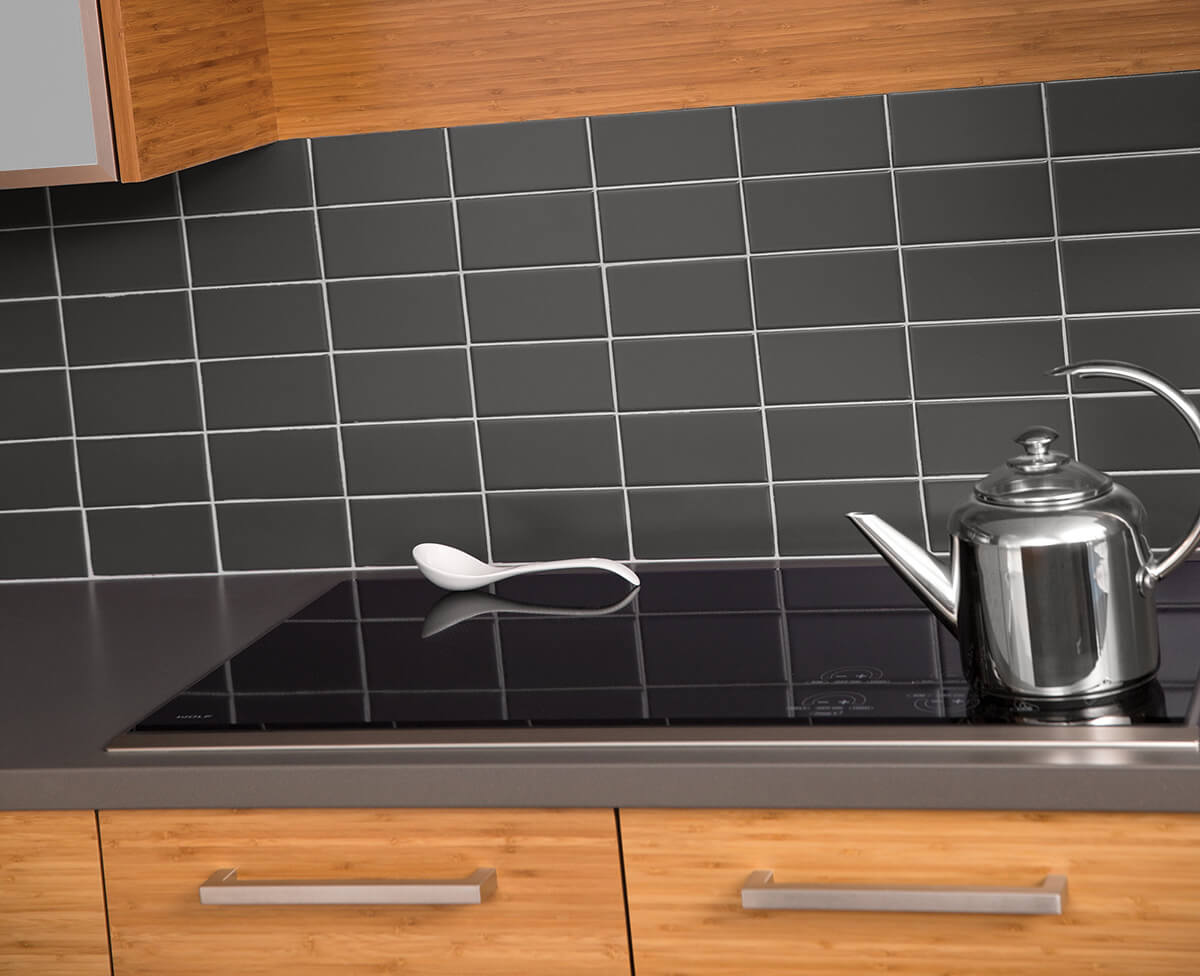 An electric cooktop in a Dura Supreme kitchen with Bamboo exotic veneer cabinets.