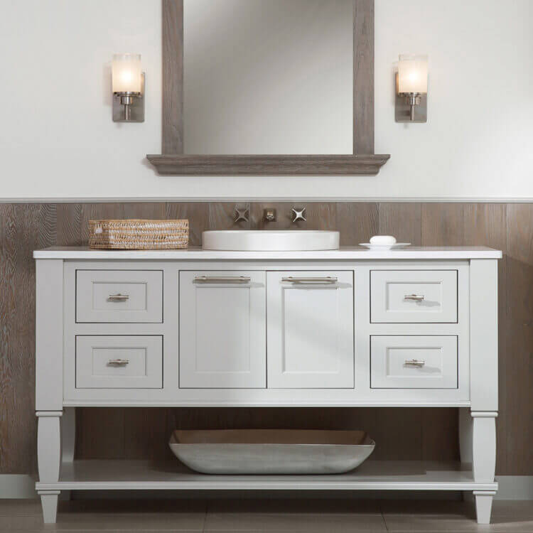 A light gray painted inset cabinets on a furniture styled vanity with weathered wood wall accents and mirror frame.