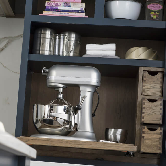 A larder pantry cabinet designed as a baking center with space for a mixer.