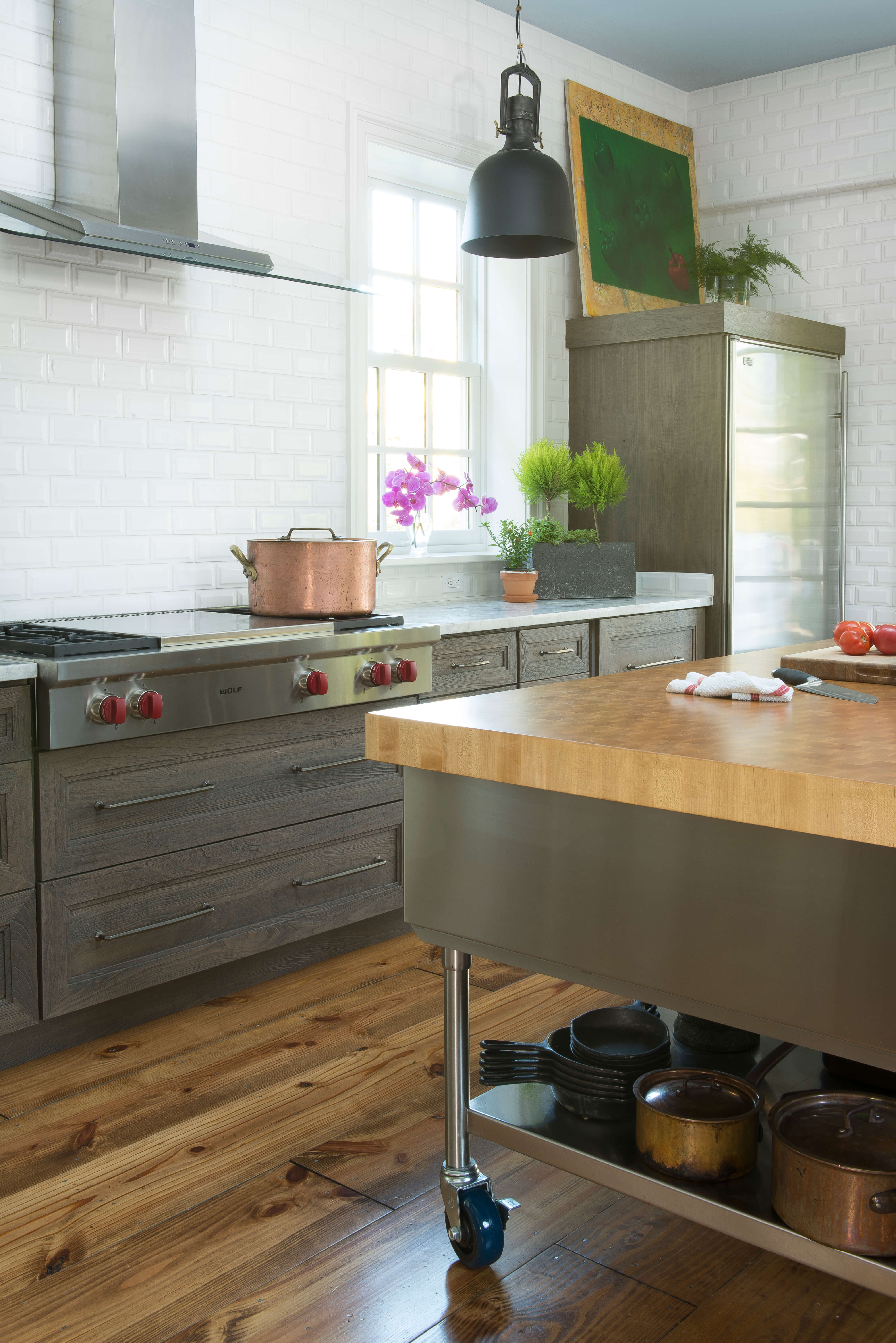 White subway tiles are used in both kitchens to tie the 2 designs together.