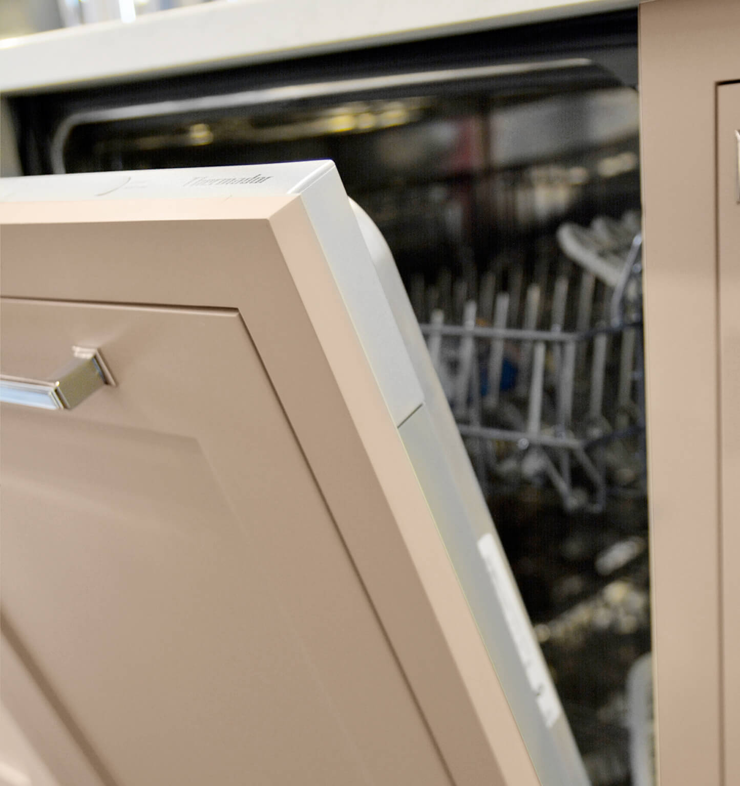 A dishwasher is hidden with a Dura Supreme cabinet appliance panel from Dura Supreme Cabinetry.