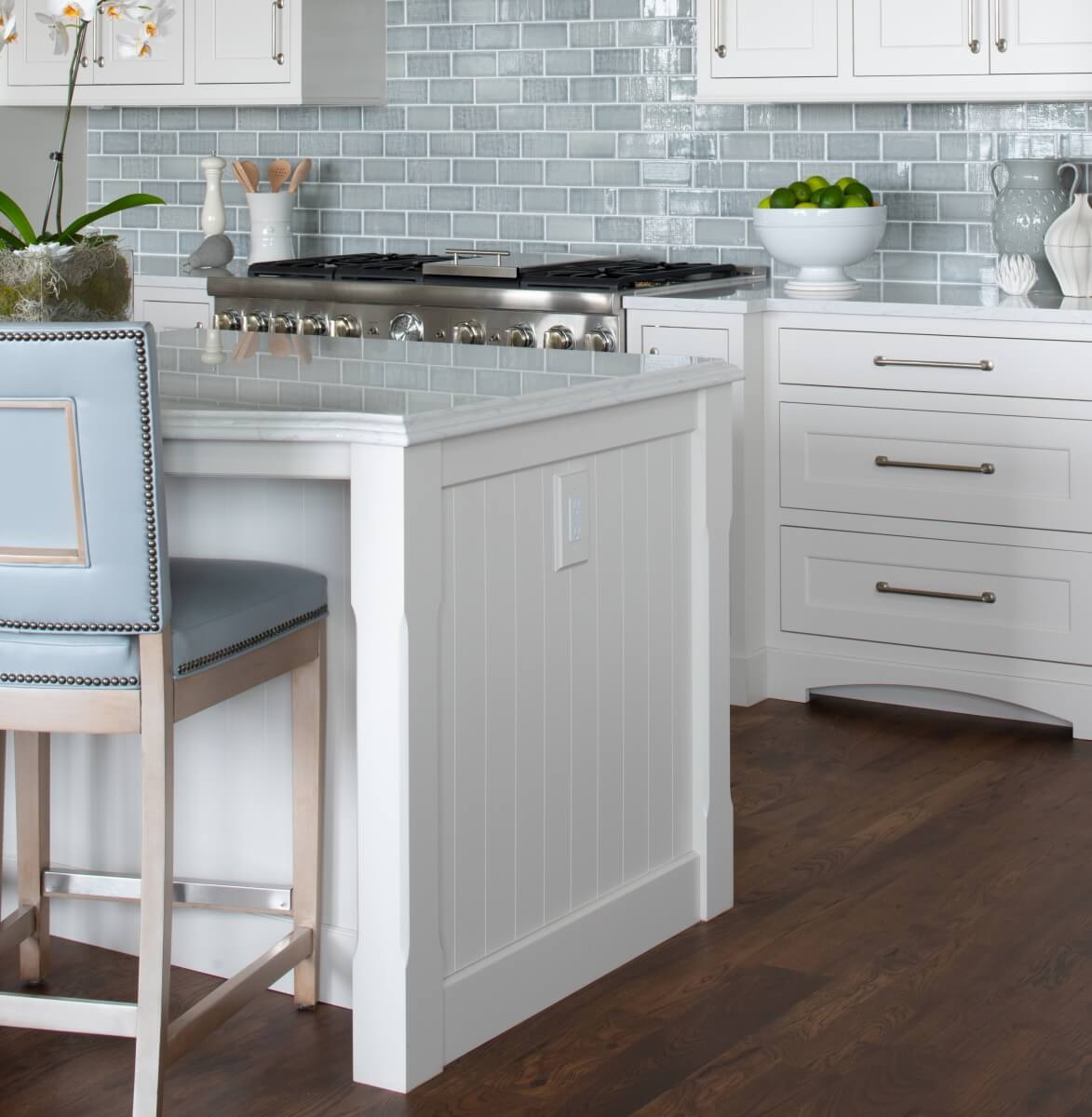A coastal style kitchen island end cap with v-groove panel that looks like shiplap shown in a white paint color.