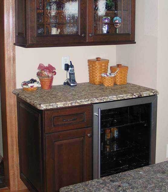 In addition to the light rail molding and the countertop extending over the door casing on the left - the countertop extends beyond the wall on the right.