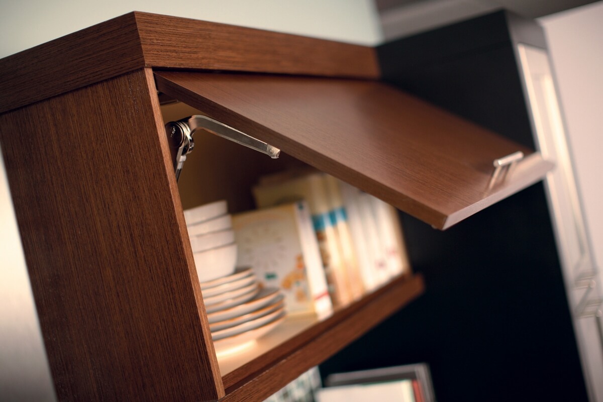 A Wall Stay-Lift Cabinet Door from Dura Supreme Cabinetry with a hinge-top mechanism that works best for reaching upper storage areas.