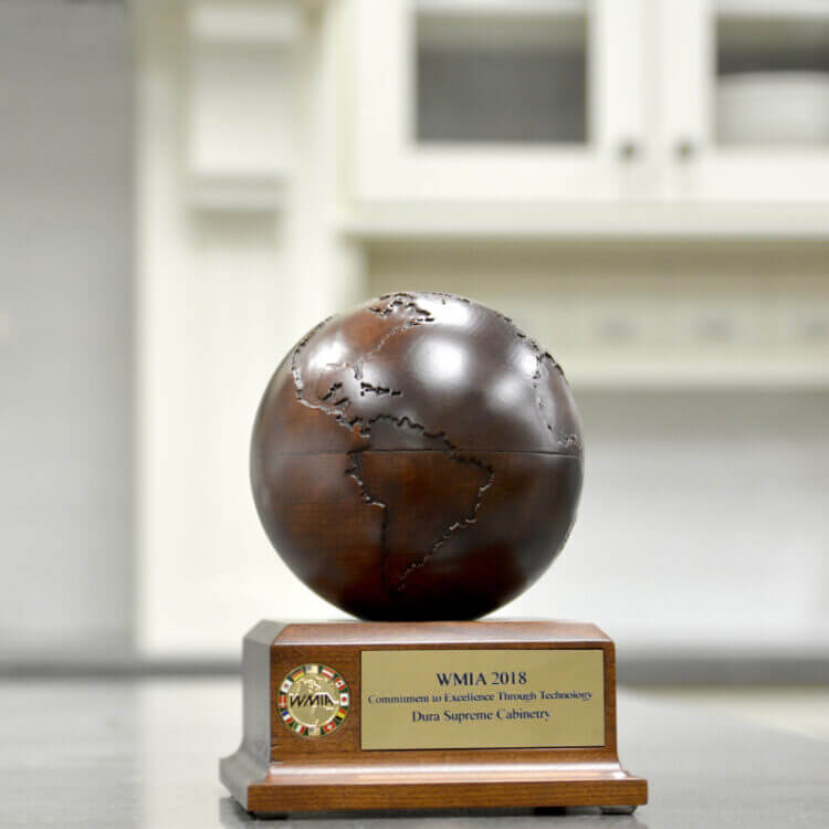 A trophy that Dura Supreme Cabinetry received as top honors for Manufacturing excellence from the Wooden Globe Awards.