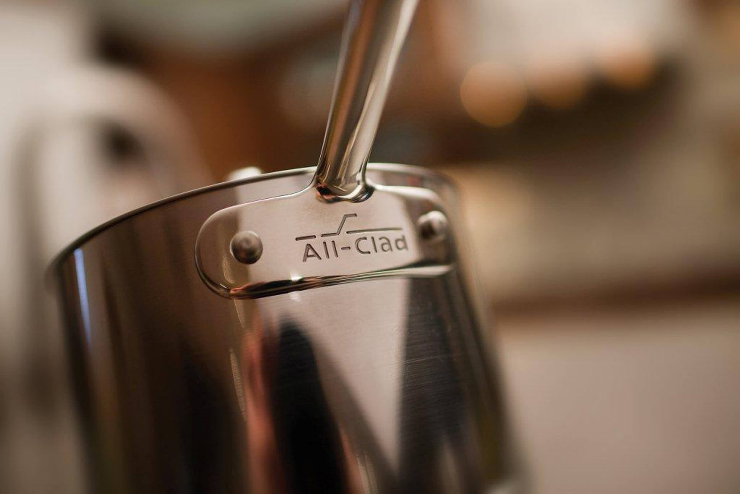 How to plan a kitchen remodel and new kitchen appliances. A close up photo of a stainless steel pot on a stove top of a remodeled kitchen.