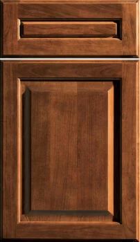 A traditional to transitional styled raised panel door style with a dark red/orange stain on cherry wood from Dura Supreme Cabinetry.