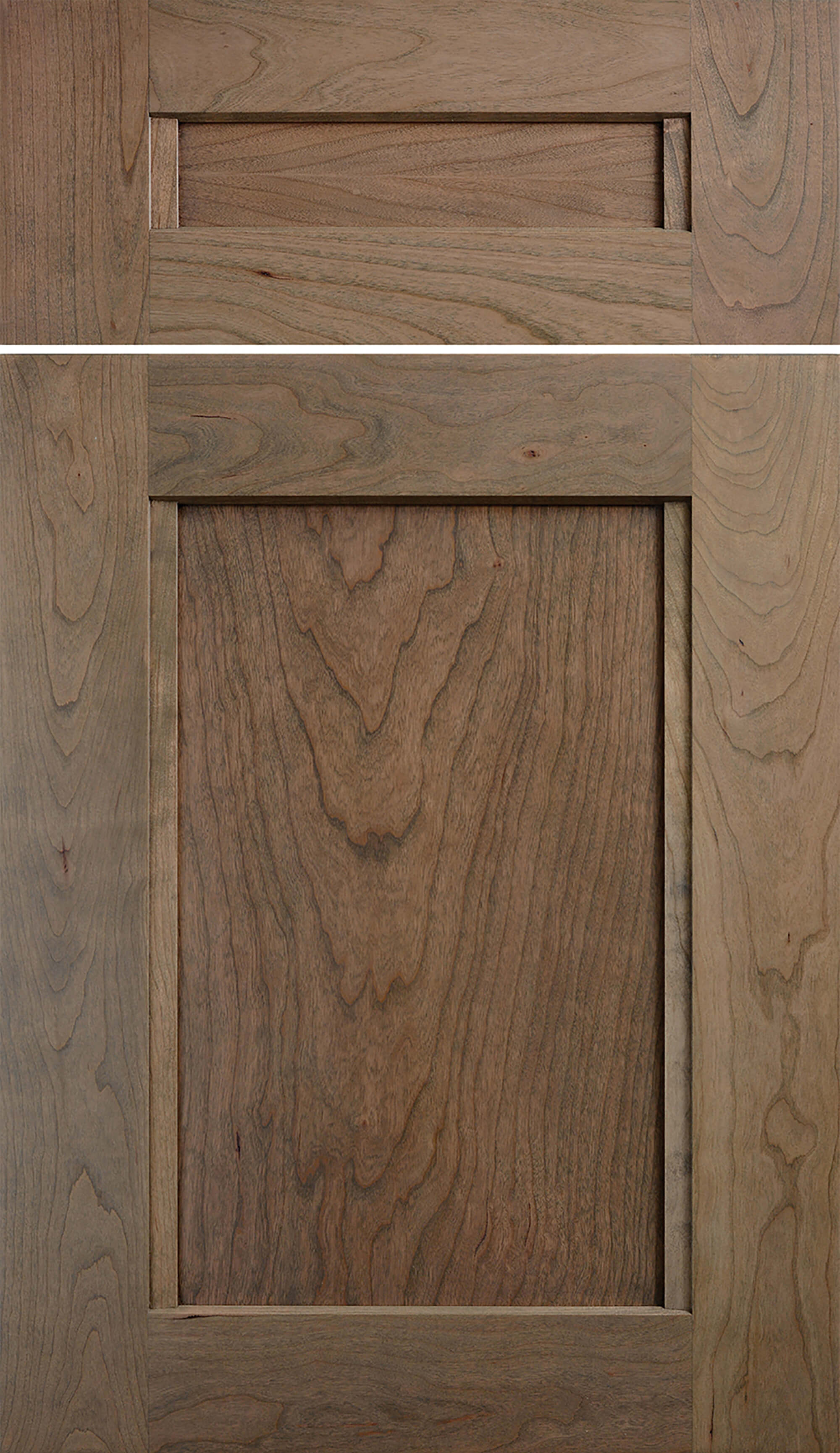 A flat panel door style called Avery from Dura Supreme Cabinetry shown in Cherry wood with a light gray-brown stained finish color. Cherry wood cabinets from Dura Supreme are American-made semi-custom to custom cabinets.