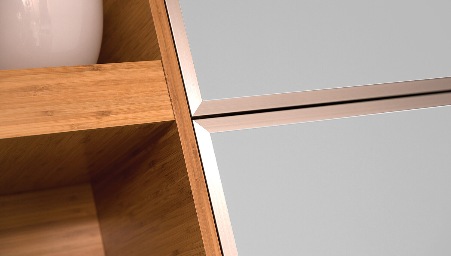 A close-up of frameless bamboo cabinets with modern aluminum framed metal accent doors.