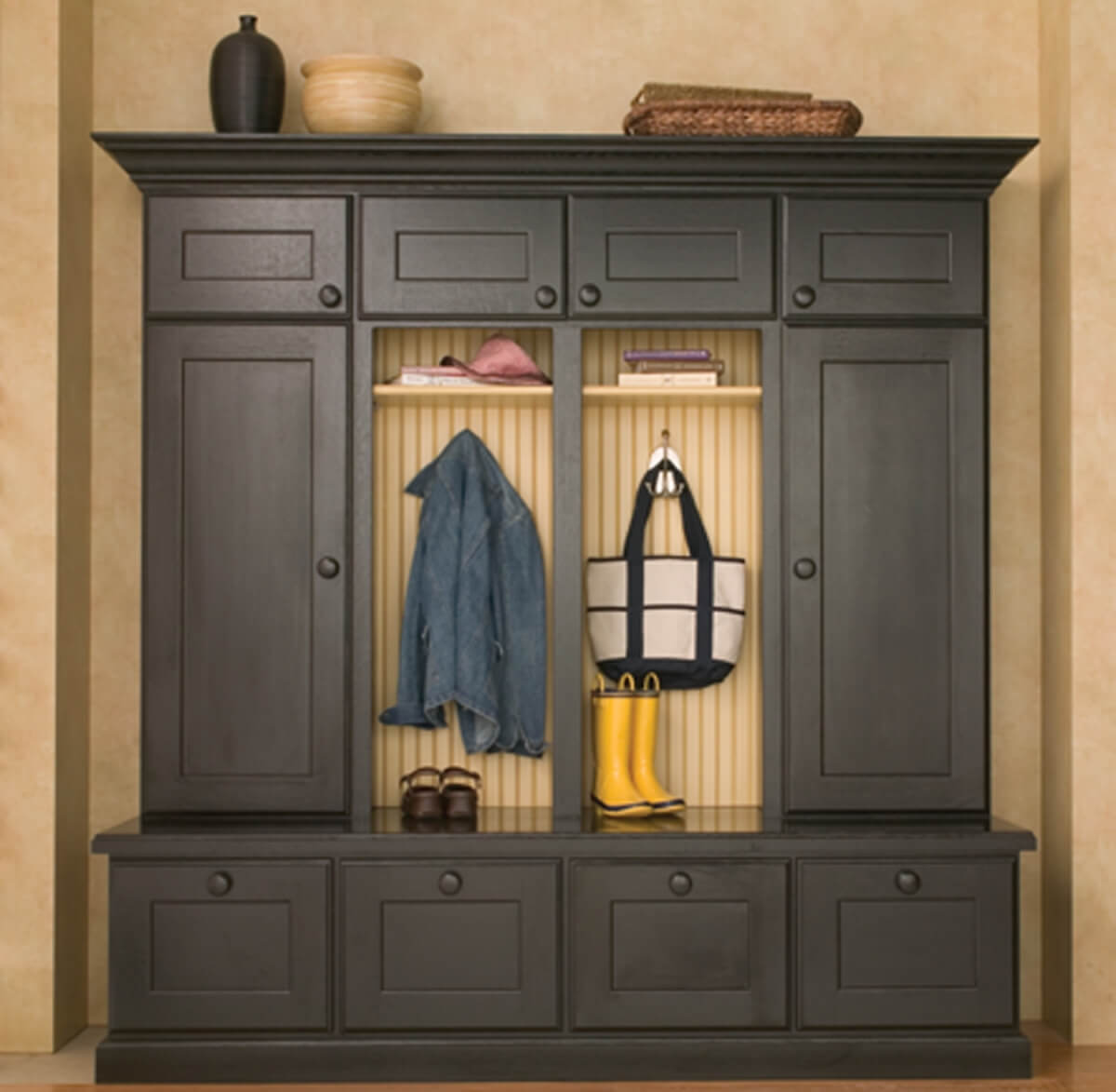 A mudroom locker unit with black painted cabinets from Dura Supreme Cabinetry.