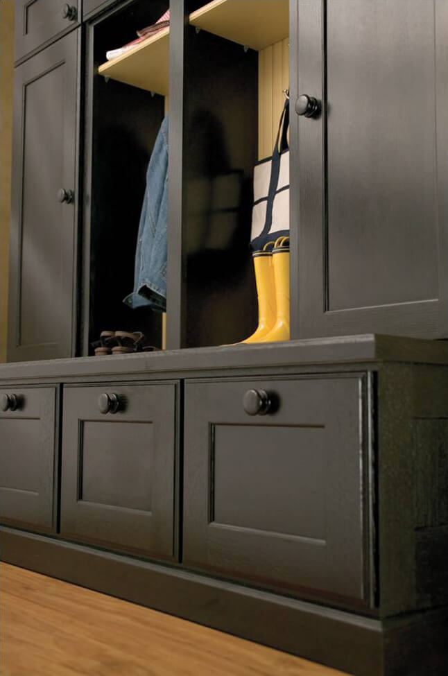 A close up of black painted cabinets in an entryway with mudroom lockers.