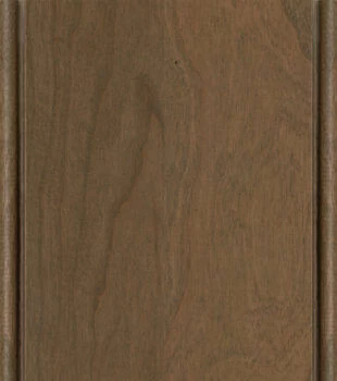 This finish color for Cherry kitchen & bath cabinets is shown in the Cashew stain with a Coffee glazed finish by Dura Supreme Cabinetry. A light to medium stain & glazed cabinet color with a brown-gray undertone.